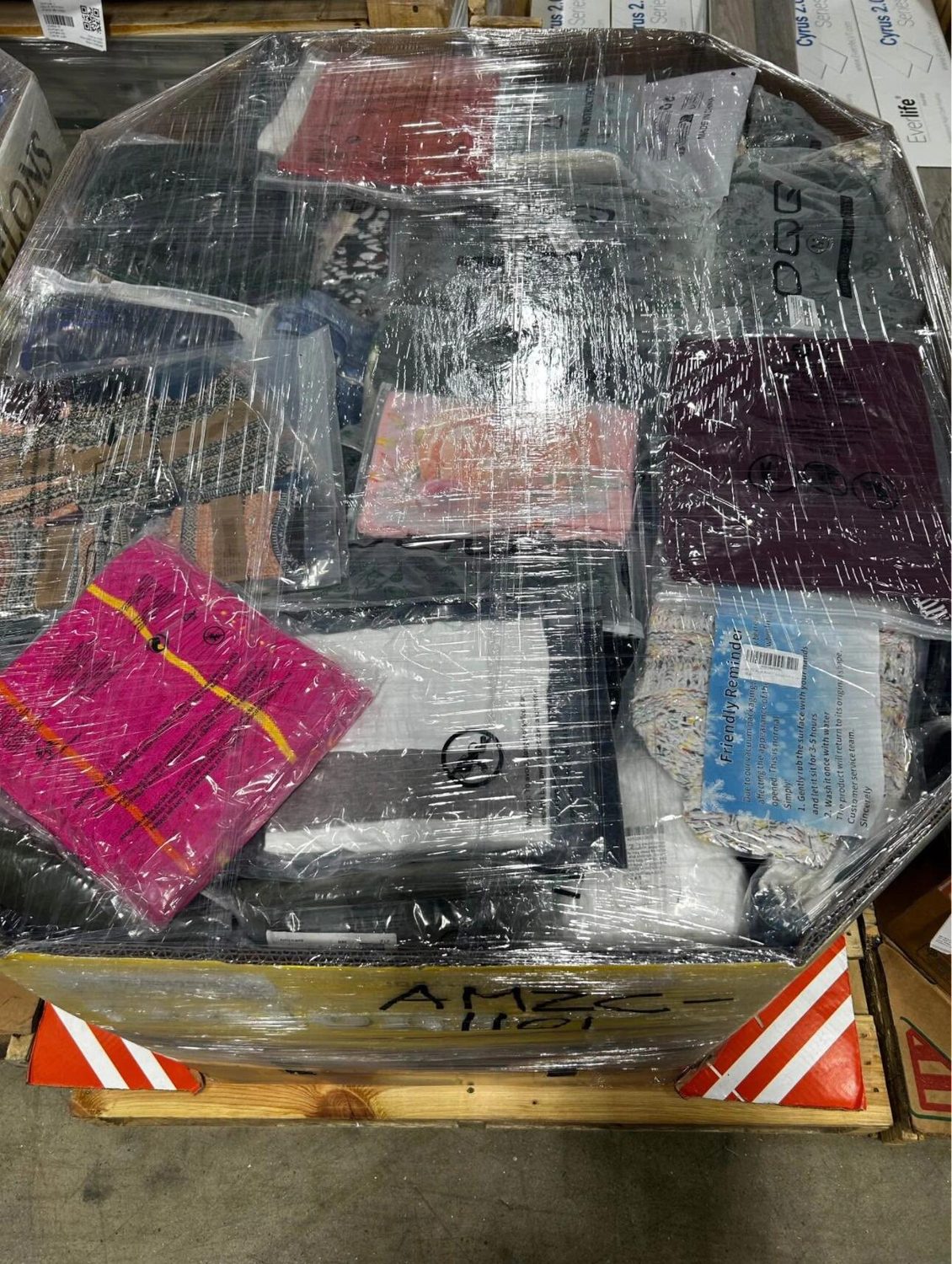 Mixed colorful clothing bulk assortment wrapped on a pallet